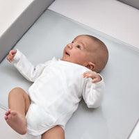 newborn laying in a next to me bed with a beddybyes silver grey Silk Universal Travel Slip