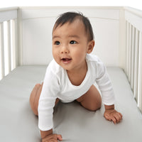 gorgeous little boy laying on a beddybyes silver grey Silk Cotbed Fitted Sheet