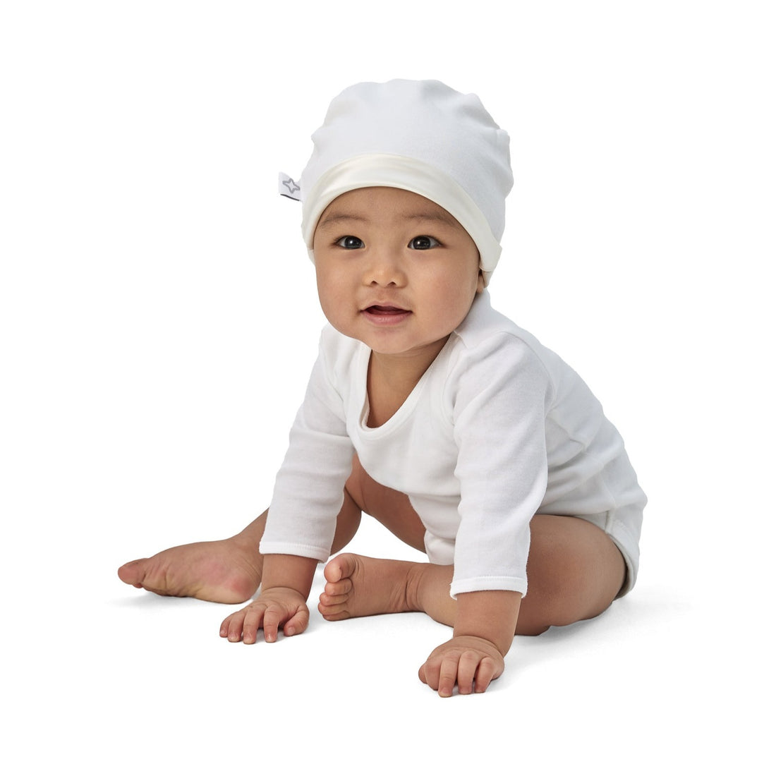 Baby boy wearing BeddyByes Snow White Silk Cotton Baby Hat