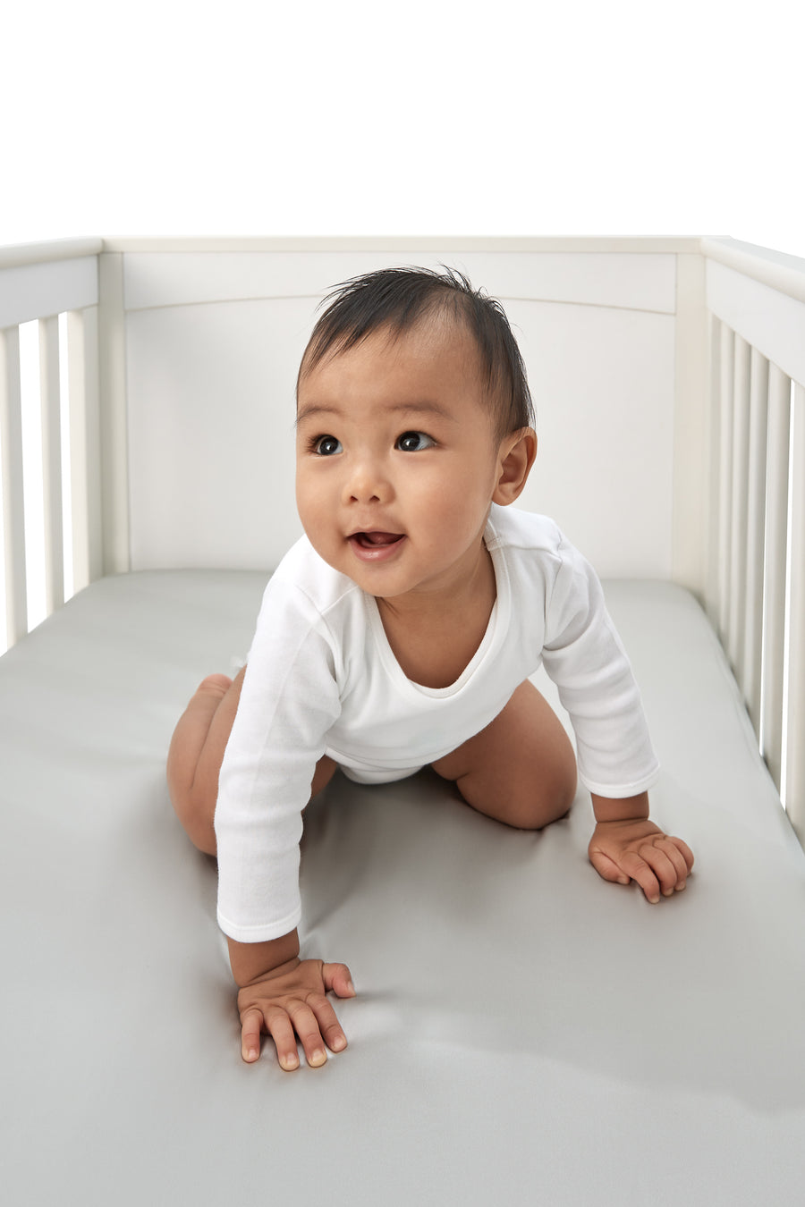 gorgeous little boy laying on a beddybyes silver grey Silk Cotbed Fitted Sheet