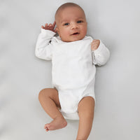 adorable little baby boy laying on a beddybyes silver grey Silk Cotbed Fitted Sheet