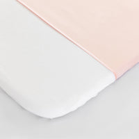 close up detail of Silk Universal Travel Slip Blush Pink colour on mattress