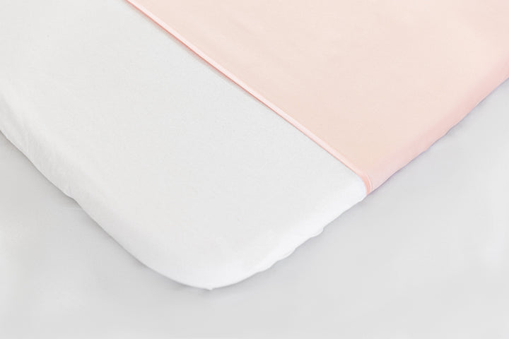 close up detail of Silk Universal Travel Slip Blush Pink colour on mattress